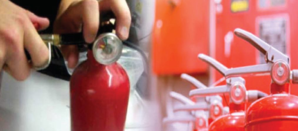 Technician servicing a fire extinguisher